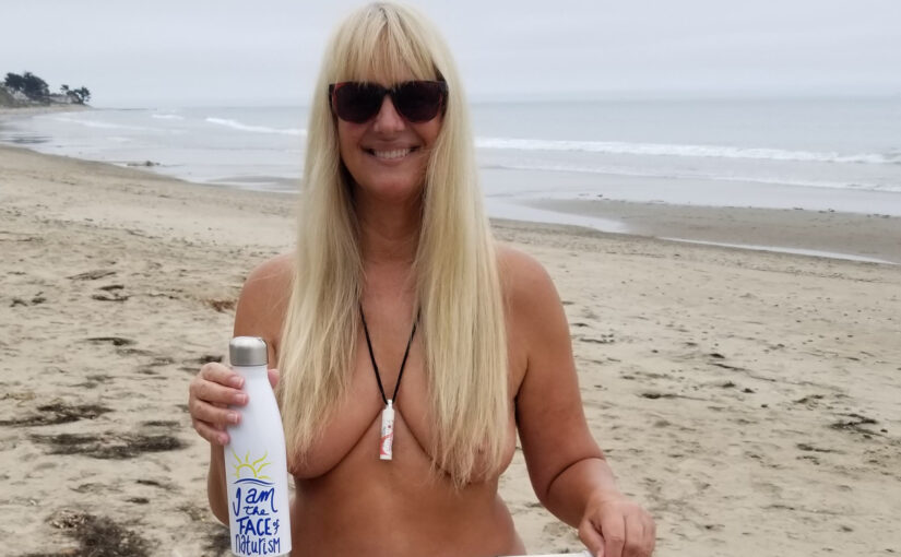 Linda Webber holding a bottle with the 2020 naturist symbol